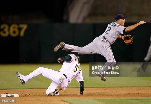 Kevin Kouzmanoff of the Oakland Athletics is out at second base as Jack Wilson of the Seattle Mariners turns a double play in the eighth inning at...