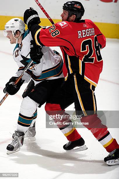 Robyn Regehr of the Calgary Flames skates against Torrey Mitchell of the San Jose Sharks on April 6, 2010 at Pengrowth Saddledome in Calgary,...