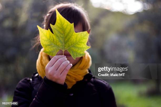 woman covering her face with a leaf - iñaki mt stock pictures, royalty-free photos & images