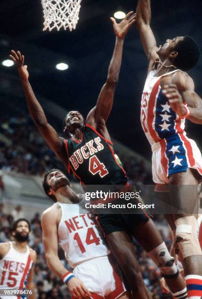 Sidney Moncrief of the Milwaukee Bucks shoots over George Johnson of the New Jersey Nets during an NBA basketball game circa 1979 at the Rutgers...
