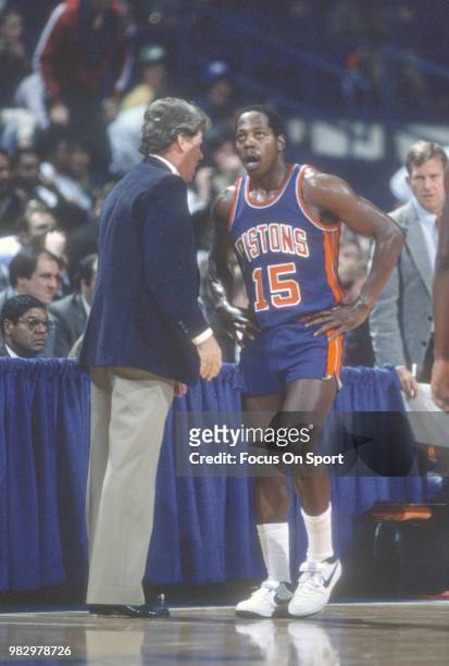 Vinnie Johnson of the Detroit Pistons talks with head coach Chuck Daly against the Washington Bullets during an NBA basketball game circa 1983 at the...