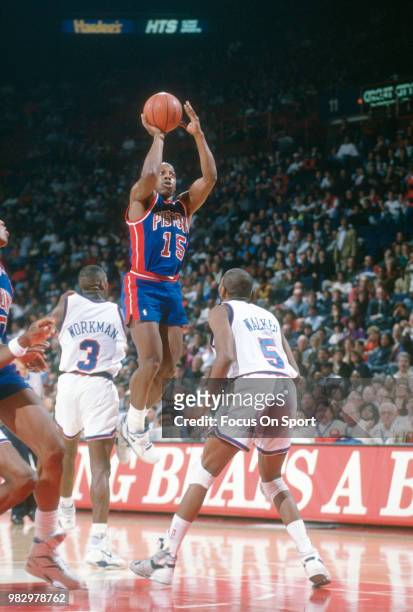 Vinnie Johnson of the Detroit Pistons shoots over Haywoode Workman of the Washington Bullets during an NBA basketball game circa 1990 at the Capital...