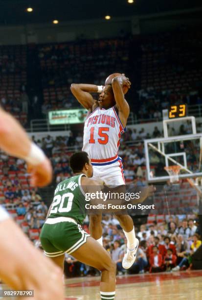 Vinnie Johnson of the Detroit Pistons shoots over Ray Williams of the Boston Celtics during an NBA basketball game circa 1985 at The Pontiac...