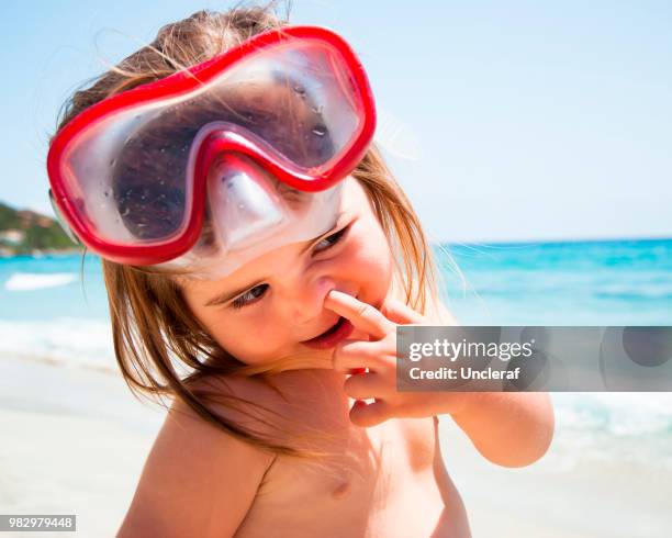 cute little girl with finger into the nose - finger goggles stock pictures, royalty-free photos & images