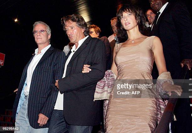 French director Alain Monne , flanked by French actors Sophie Marceau and Christophe Lambert, arrives to the presentation of his last movie "L'homme...