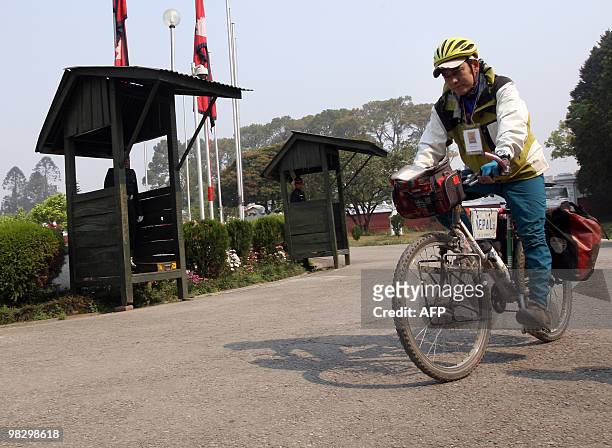 Nepalese cyclist Pushkar Shah arrievs at The President's House in Kathmandu on April 7 as he prepares to leave for Mount Everest after an 11-year...