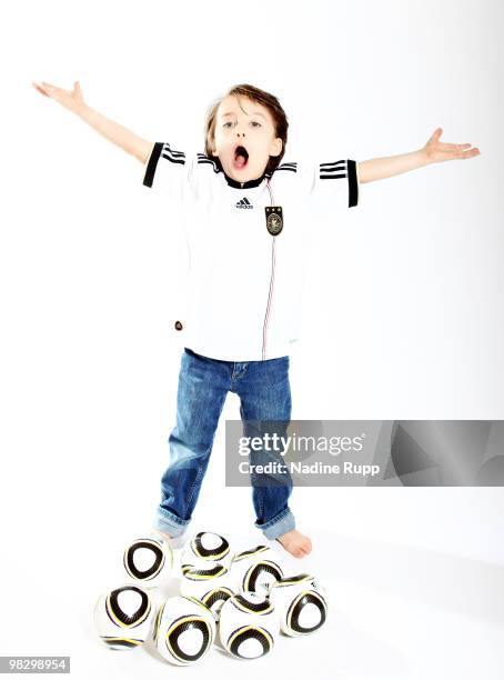 Germany fan child Aurele Rupp poses in the original german national trikot with World Cup 2010 mini ball Jabulani during a photo session on March 6,...