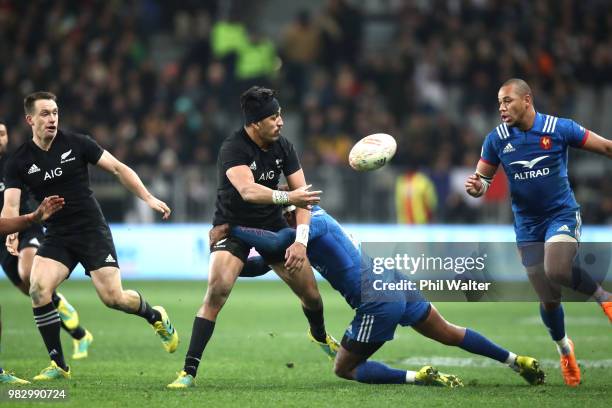 Reiko Ioane of the All Blacks passes during the International Test match between the New Zealand All Blacks and France at Forsyth Barr Stadium on...