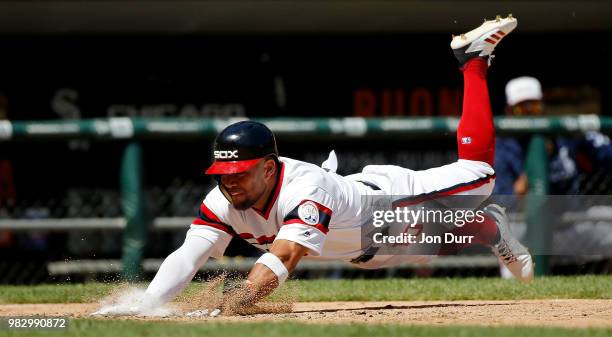 Yoan Moncada of the Chicago White Sox dives to score on an RBI single hit by Avisail Garcia against the Oakland Athletics during the sixth inning...