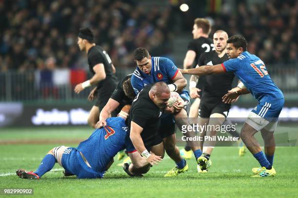 Karl Tu'inukuafe of the New Zealand All Blacks is tackled during the International Test match between the New Zealand All Blacks and France at...