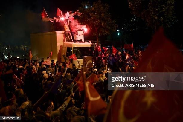 People react outside the Justice and Development Party headquarters in Istanbul, on June 24 during the Turkish presidential and parliamentary...