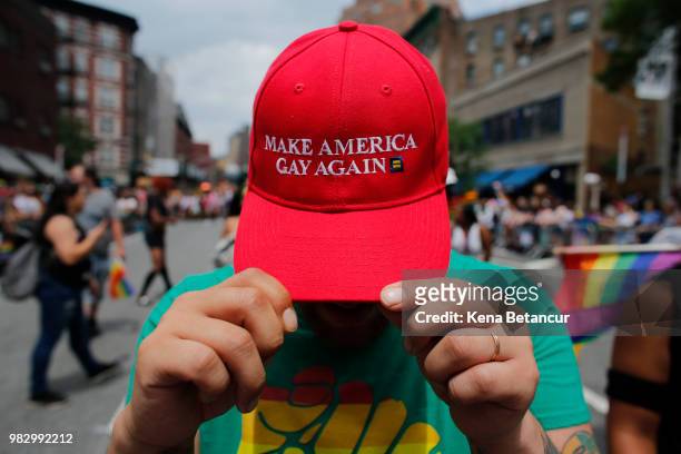 Reveller shows off his hat mirroring President Trump's campaign slogan Make America Great Again at the annual Pride Parade on June 24, 2018 in New...