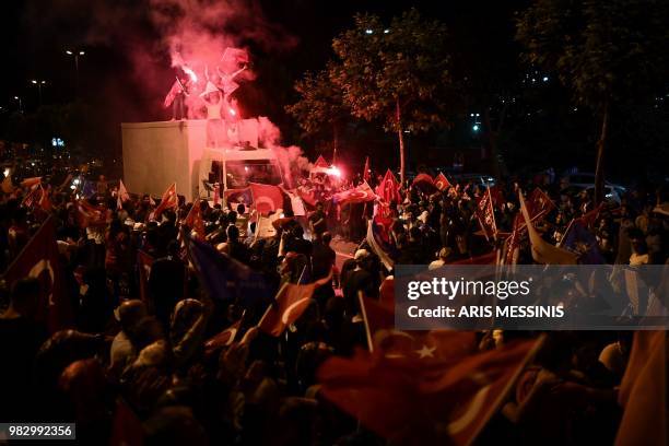 People react outside the Justice and Development Party headquarters in Istanbul, on June 24 during the Turkish presidential and parliamentary...