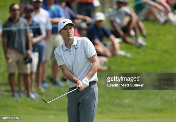 Russell Henley chips onto the green on the fourth hole during the final round of the Travelers Championship at TPC River Highlands on June 24, 2018...