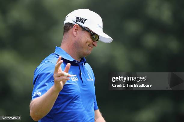 Zach Johnson of the United States acknowledges the gallery after making a putt for birdie on the fourth green during the final round of the Travelers...