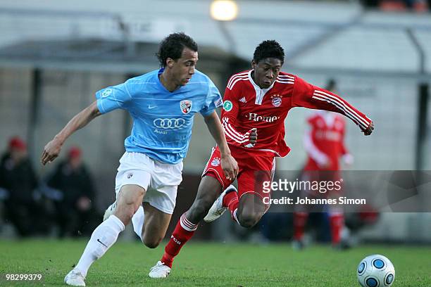 David Alaba of Bayern and Moise Bambara of Ingolstadt fight vor the ball during the 3rd League match FC Bayern Muenchen II vs FC Ingolstadt at...