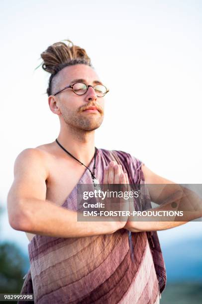 man in his twenties with long blonde dreadlocks does yoga - ems forster productions stock pictures, royalty-free photos & images