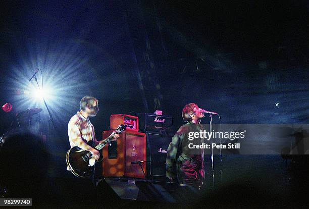 Paul 'Bonehead' Arthurs and Liam Gallagher of Oasis perform on stage at the Glastonbury Festival on June 23th, 1995 in Somerset, England.