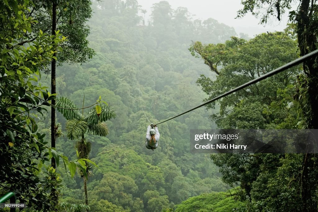 A person zip lining above a forest in Costa Rica.