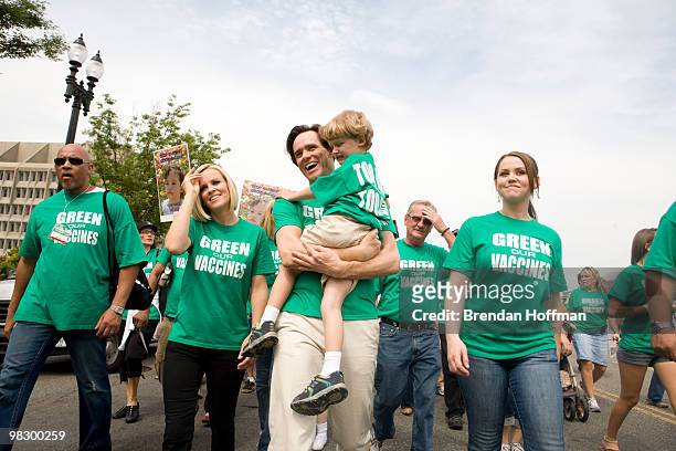 Actor Jim Carrey holds Evan McCarthy, son of actress Jenny McCarthy during a march calling for healthier vaccines June 4, 2008 in Washington, DC....