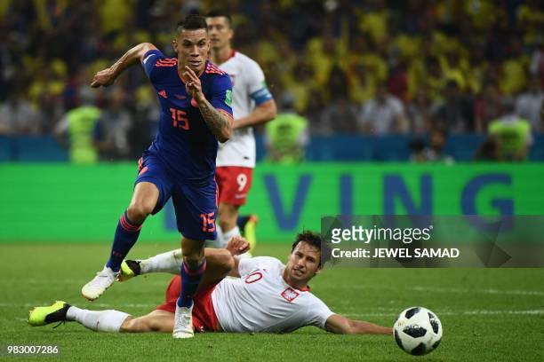 Colombia's midfielder Mateus Uribe vies with Poland's midfielder Grzegorz Krychowiak during the Russia 2018 World Cup Group H football match between...