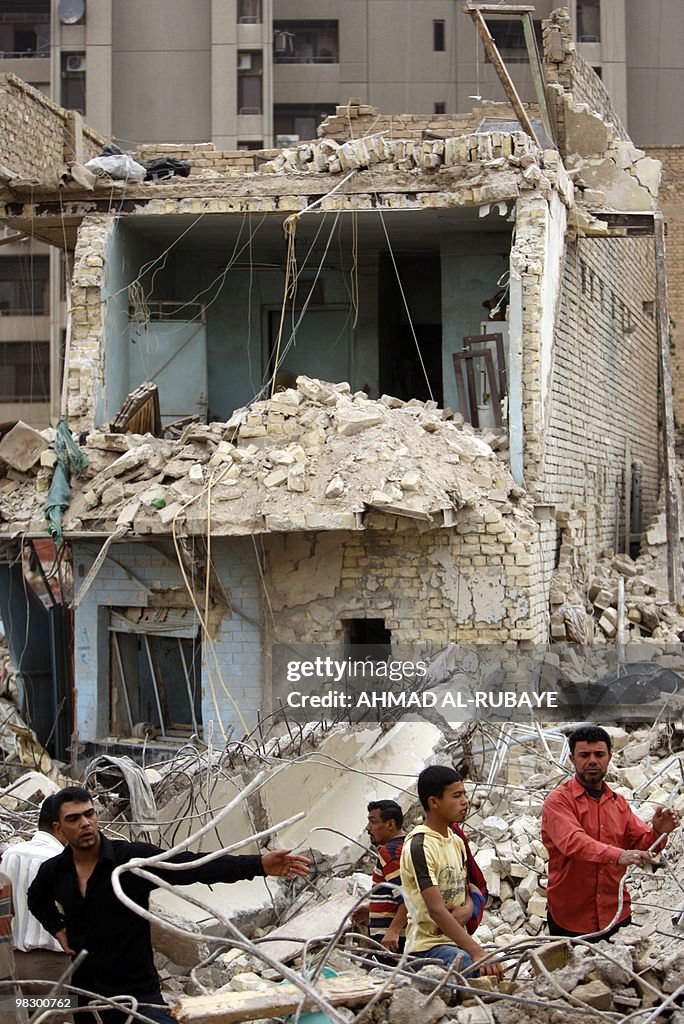 House Rumble Iraq Iraqi men inspect the rubble of homes destroyed in a bomb attack in ...