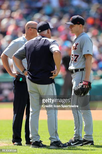 Detroit Tigers manager Ron Gardenhire and a trainer examine Detroit Tigers pitcher Artie Lewicki after Lewicki was hit by a ball hit up the middle by...