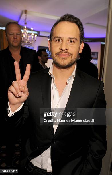 Actor Moritz Bleibtreu makes the peace sign during a photocall at the Hotel Bayerischer Hof on April 7, 2010 in Munich, Germany.