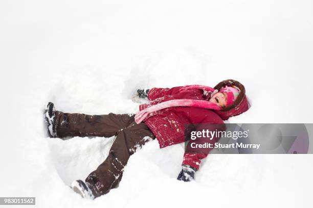 a girl in pink playing in snow in ontario, canada. - angel pink stock pictures, royalty-free photos & images