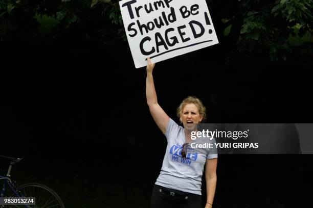 President Donald Trump's motorcade passes by a protestor outside Trump National Golf Club in Sterling, Virginia on June 24, 2018.