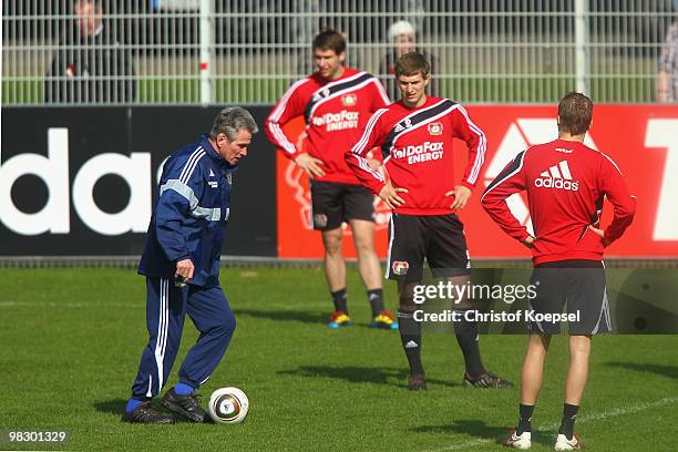 Head coach Jupp Heynckes of Leverkusen gives instructions to Patrick Helmes and Daniel Schwaab druing the training session of Bayer Leverkusen at the...