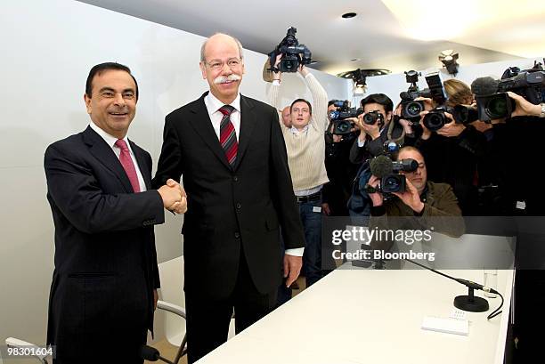 Carlos Ghosn, chief executive officer of Renault SA, left, greets Dieter Zetsche, chief executive officer of Daimler AG, center, ahead of their joint...