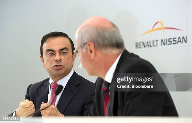 Carlos Ghosn, chief executive officer of Renault SA, left, gestures as Dieter Zetsche, chief executive officer of Daimler AG, listens during their...