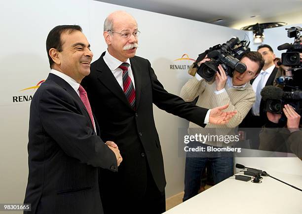 Carlos Ghosn, chief executive officer of Renault SA, left, greets Dieter Zetsche, chief executive officer of Daimler AG, center,ahead of their joint...