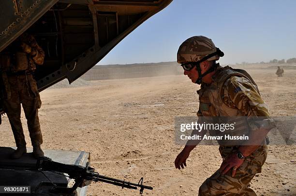 Prince Charles, Prince of Wales boards RAF Chinook at Camp Bastion on March 25, 2010 in Nad-e Ali, Afghanistan. Prince Charles arrived in Afghanistan...