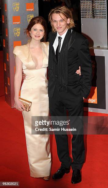 Bonnie Wright and Jamie Campbell Bower arrive at the Orange British Academy Film Awards 2010 at the Royal Opera House on February 21, 2010 in London,...