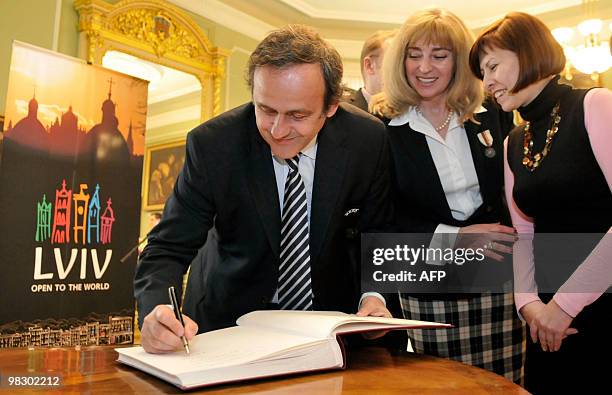 President Michel Platini Nsigns a guest book following his inspection of the construction site of the Lviv stadium in Lviv on April 7, 2010. Platini...