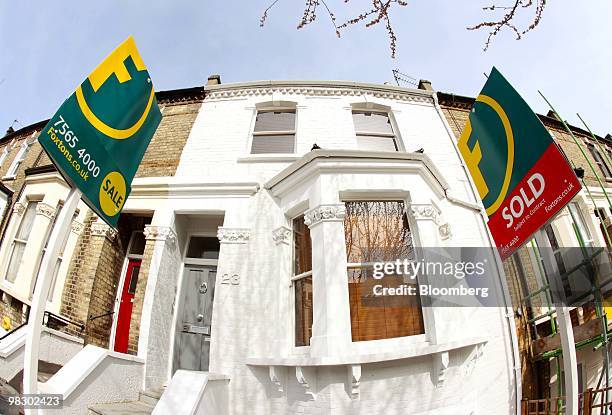 For sale and sold sign stand outside residential properties in London, U.K., on Tuesday, April 6, 2010. U.K. Mortgage approvals unexpectedly fell to...