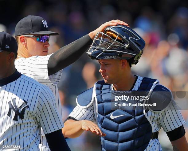 Aaron Judge of the New York Yankees pats teammate Gary Sanchez on the head as they celebrate their win at the end of an MLB baseball game against the...