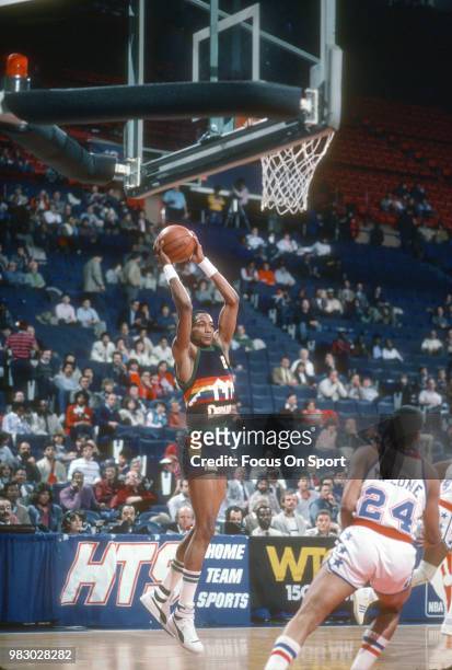 Alex English of the Denver Nuggets grabs a rebound against the Washington Bullets during an NBA basketball game circa 1984 at the Capital Centre in...