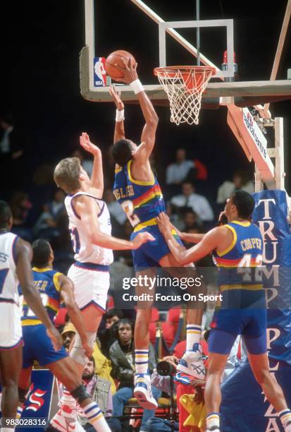 Alex English of the Denver Nuggets goes up to shoot against the Washington Bullets during an NBA basketball game circa 1989 at the Capital Centre in...