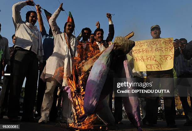 Opposition Bharatiya Janata Party supporters chant slogans as they burn an effigy of Indian Home Minister P. Chidambaram in Allahabad on April 7...