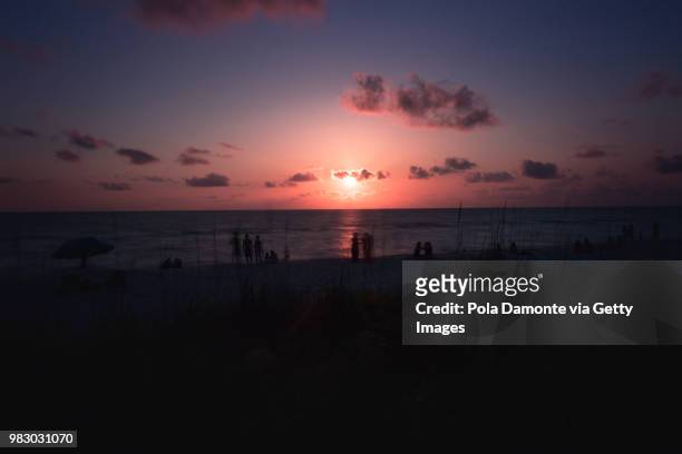 naples beach amazing sunset and calm ocean, florida, usa - pola damonte stock pictures, royalty-free photos & images