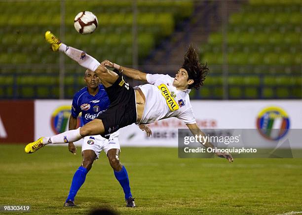 Ezequiel Miralles of Chile's Colo Colo jumps for kick the ball against of Deportivo Italia during their match as part of 2010 Libertadores Cup on...