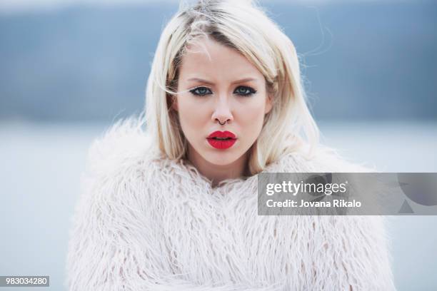 portrait of a young woman in a fur jacket. - jovanat stock pictures, royalty-free photos & images