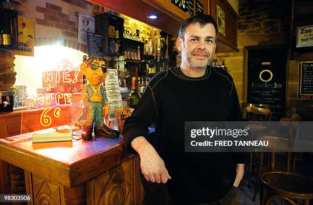 The owner of the rural "Couleur cafe" bar in Sainte-Anne du Houlin village, part of Plaine-Haute town, western France, poses in his on March 5, 2010....