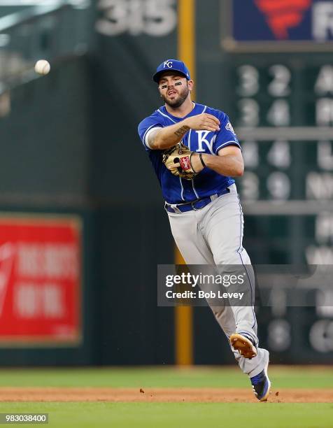 Mike Moustakas of the Kansas City Royals makes a barehanded attempt on a slow roller off the bat of Josh Reddick of the Houston Astros in the seventh...