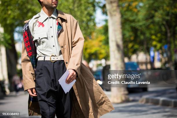 Fashion detail of Filippo Fiora green shirt, black pants and beige trench coat, is seen in the streets of Paris before the Lanvin show, during Paris...