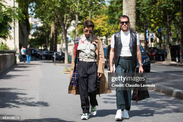 Filippo Fiora, wearing green shirt, black pants and beige trench coat and Filippo Cirulli, wearing white t shirt, green pants and black leather...