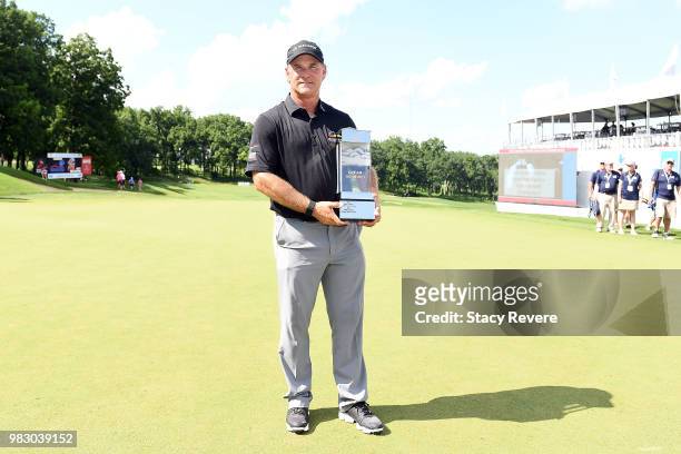Scott McCarron poses with the winner's trophy after winning the American Family Championship at University Ridge Golf Course on June 24, 2018 in...